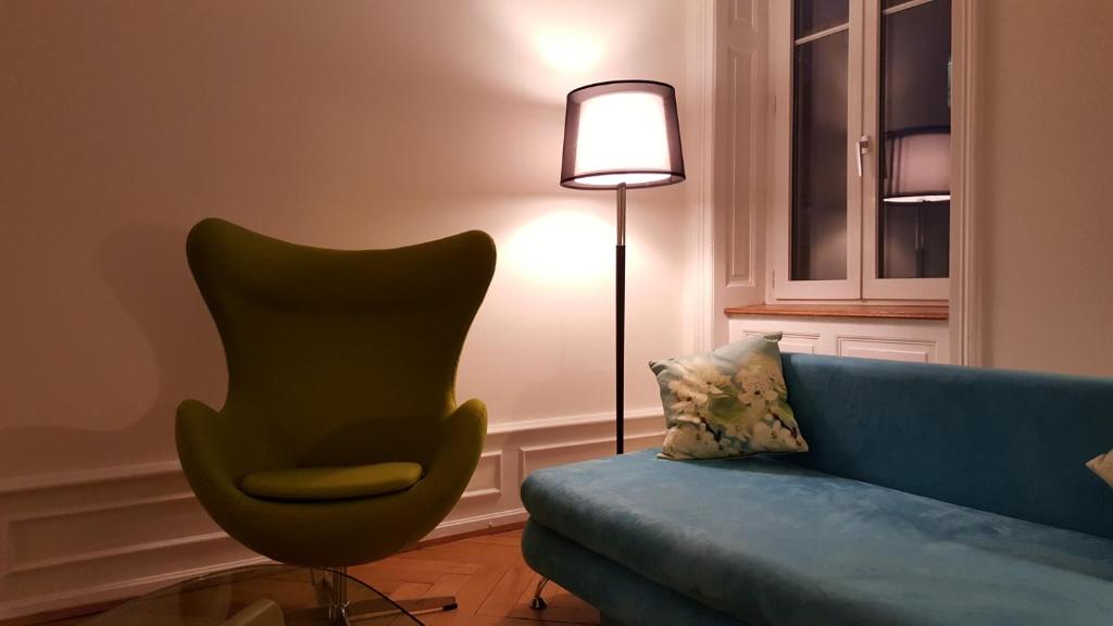 巴塞尔巴塞尔查姆公寓 的客厅配有蓝色的沙发和灯具