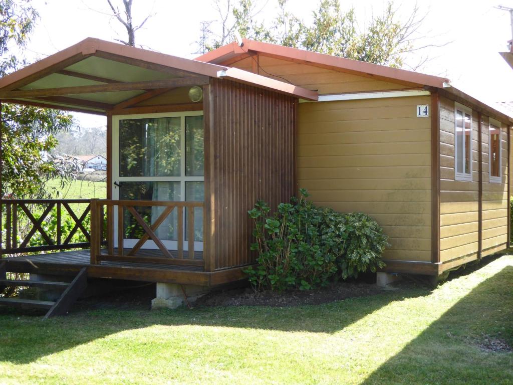 库迪列罗Camping L´Amuravela的小屋,设有草地上的门廊