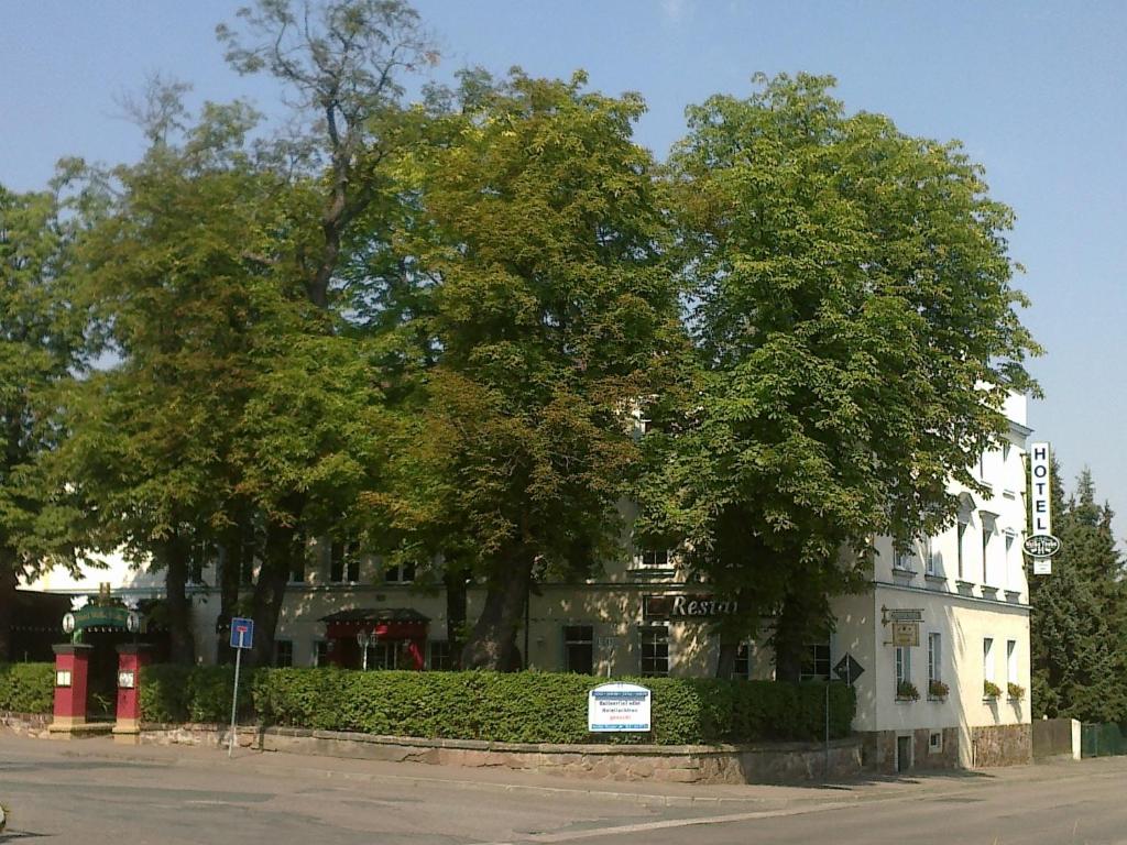 德伯尔恩维贝塔贝酒店的街道前方树木繁茂的白色建筑