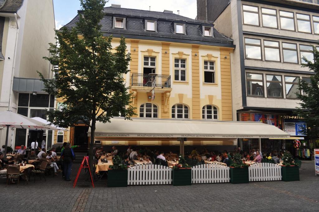 古梅尔斯巴赫Brauhaus Gummersbach GmbH的一群坐在大楼前桌旁的人