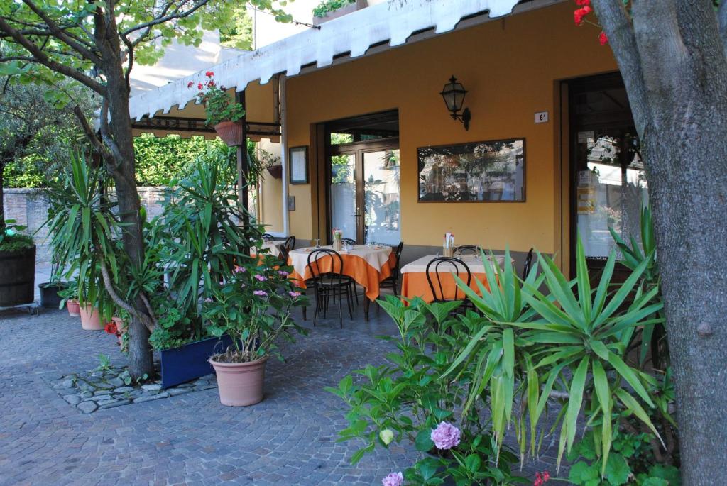 GuigliaLa Lanterna di Guiglia的一间设有桌椅和植物的餐厅