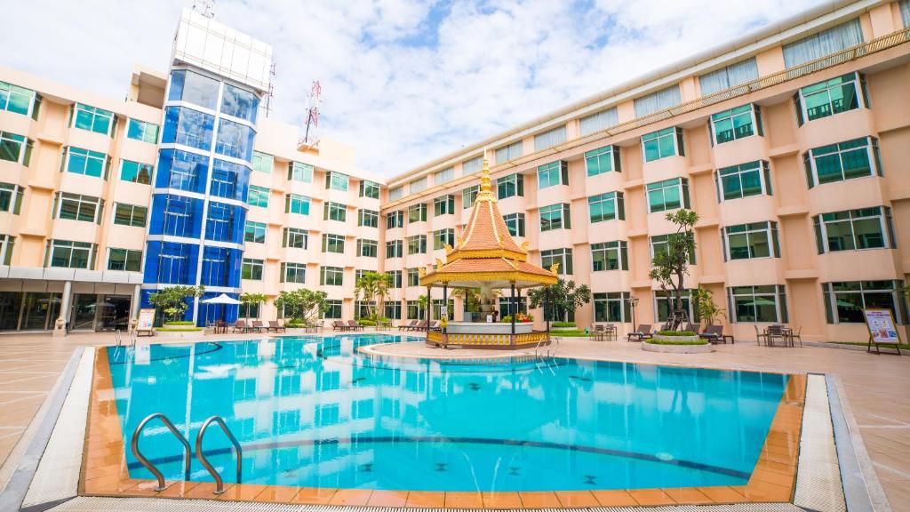 金边金边酒店的一座大型建筑,前面设有一个游泳池