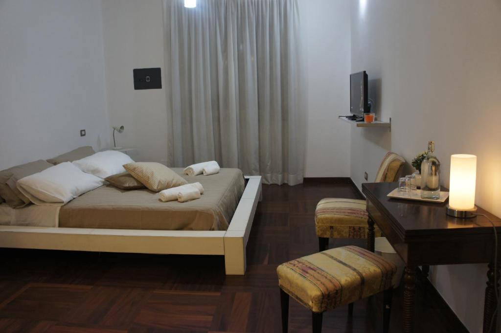 米兰奇维科40号住宿加早餐旅馆的一间卧室配有一张床、一张书桌和一台电视