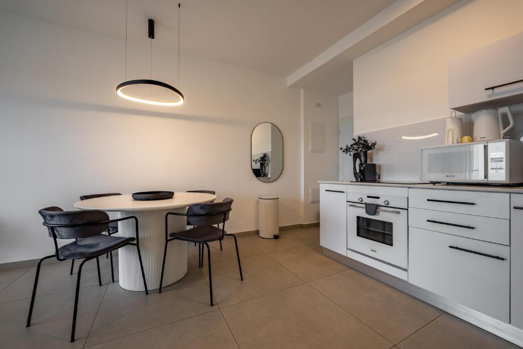 埃拉特Valencia Apartment - By Harim的房间里有一张桌子和几把椅子的厨房