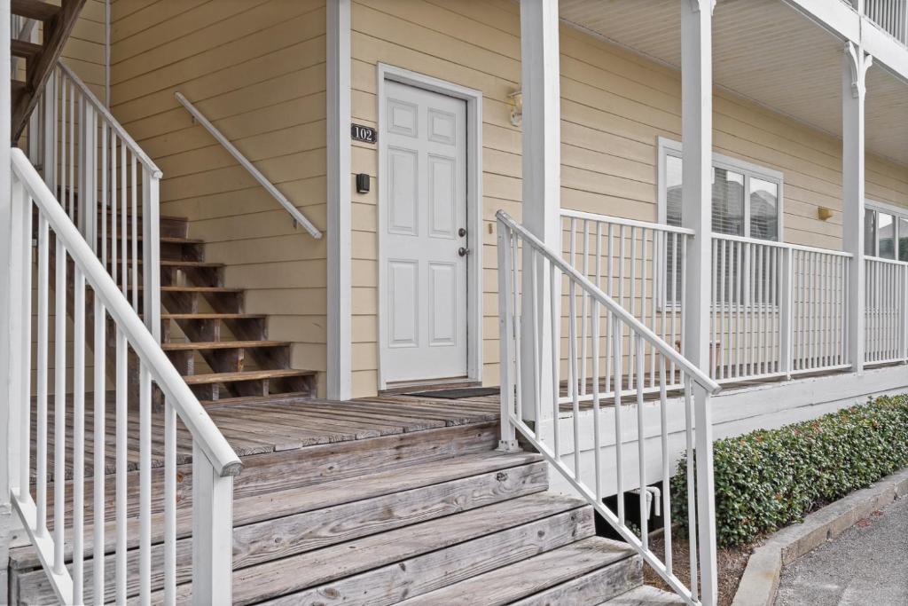 格尔夫海岸Beautiful Two Bedroom, Two Bathroom First Floor Condo in Gulf Shores!的一座房子,设有通往白色门的木楼梯