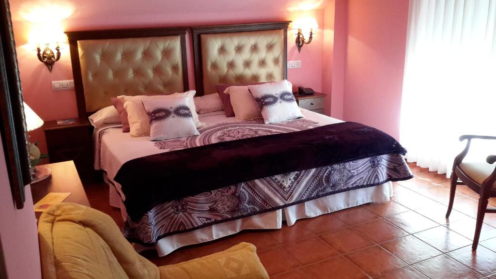 库迪列罗Hotel Boutique El Pescador的卧室配有一张带粉红色墙壁的大床