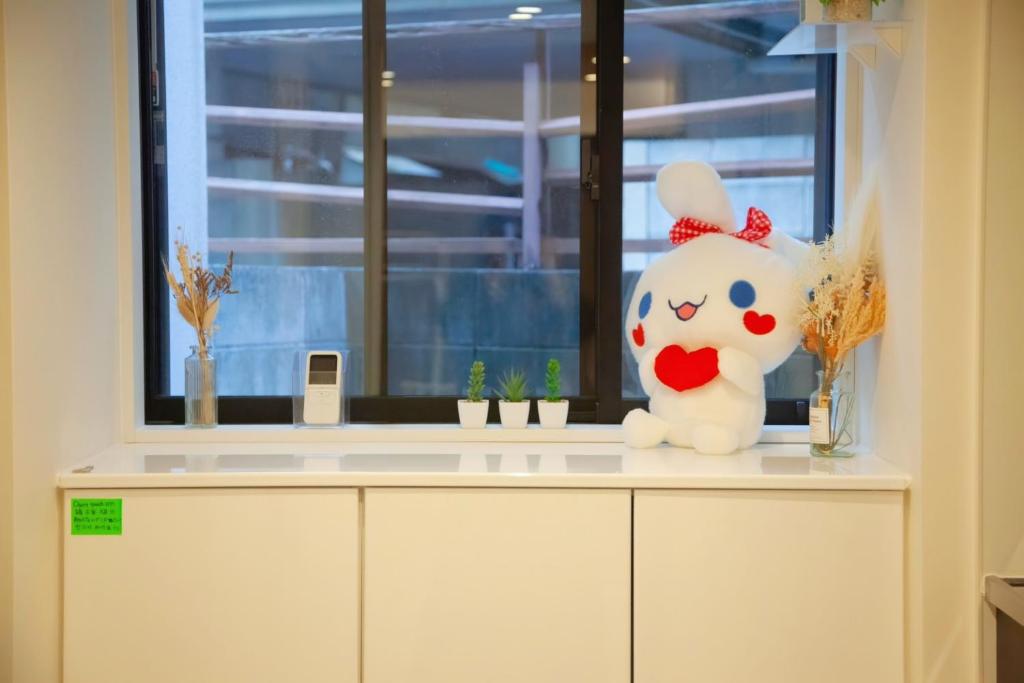 东京森下小屋的一只小猫玩具坐在窗前的柜台上