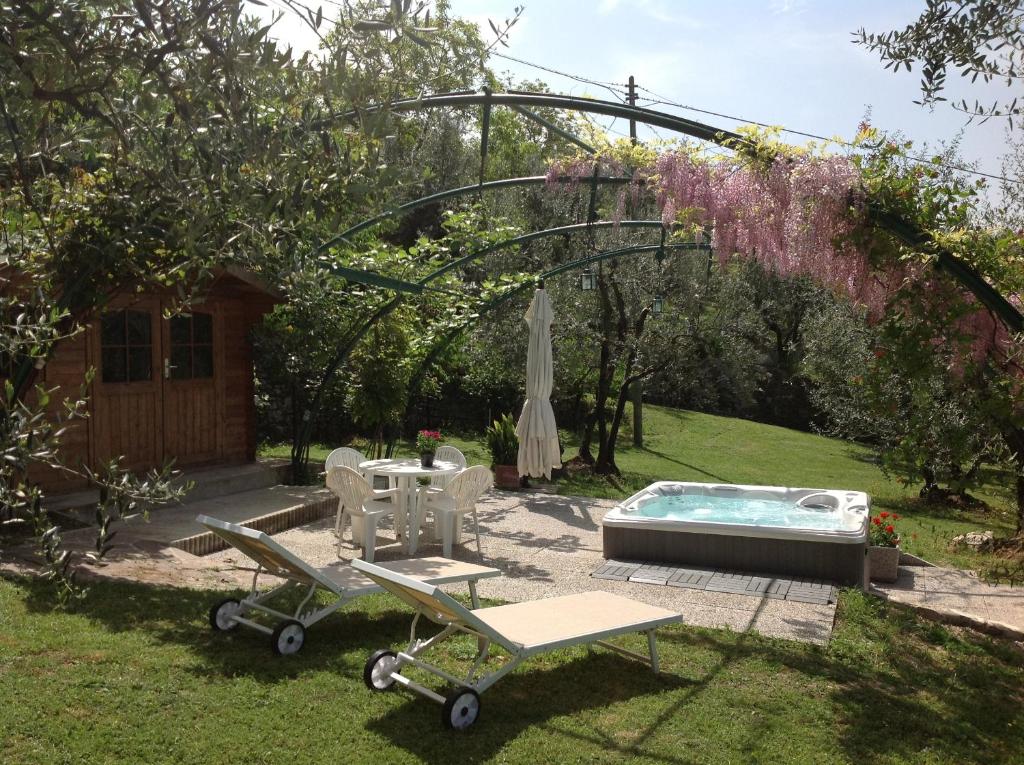巴尼奥阿里波利Casa Villamagna的后院设有热水浴池、桌子和椅子