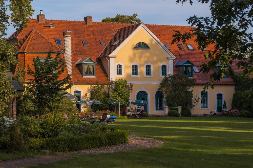 SolzowDas Gutshaus Solzow Mecklenburgische Seenplatte Müritz的一座白色的大房子,有橙色的屋顶