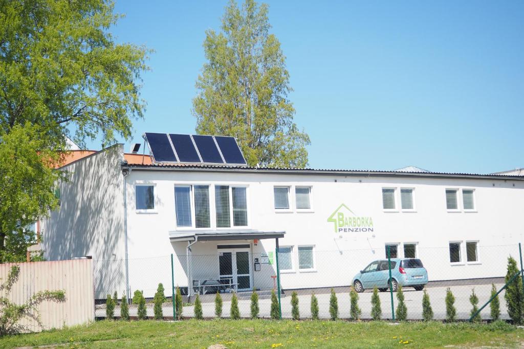 奥洛穆茨Ubytování Barborka的屋顶上设有太阳能电池板的白色建筑