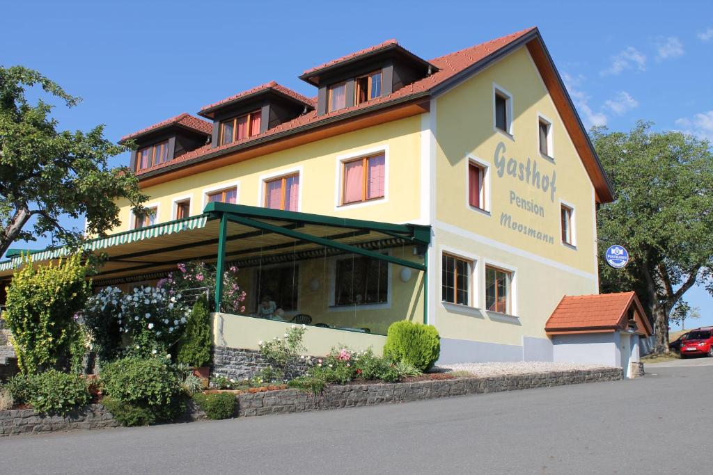 ArnfelsGasthof zum Moosmann - Familie Pachernigg的黄色的建筑,旁边标有标志