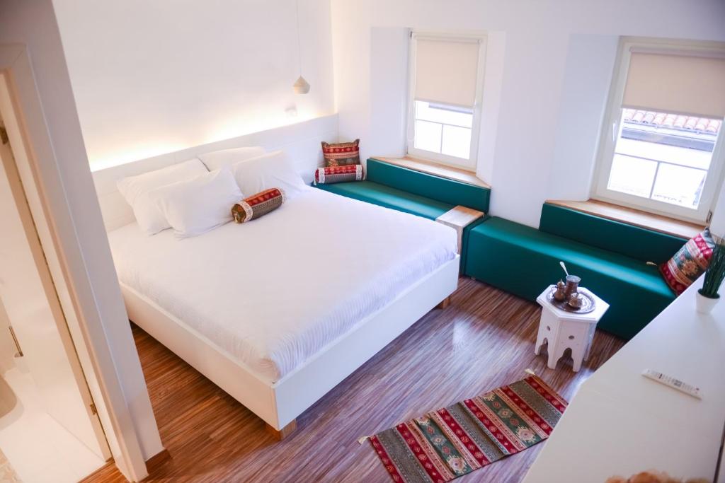 萨拉热窝萨拉热窝老城酒店的卧室设有一张白色大床和两个窗户。