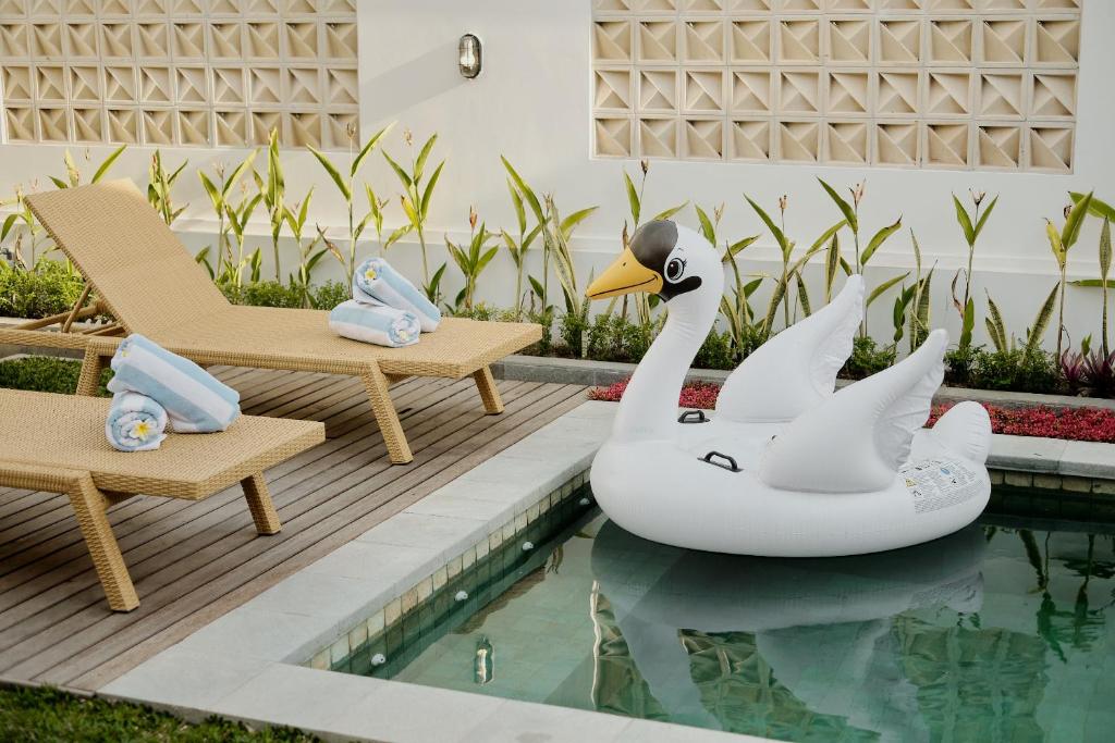 乌布Luxury Nanda villa Ubud的水中有两个天鹅的游泳池