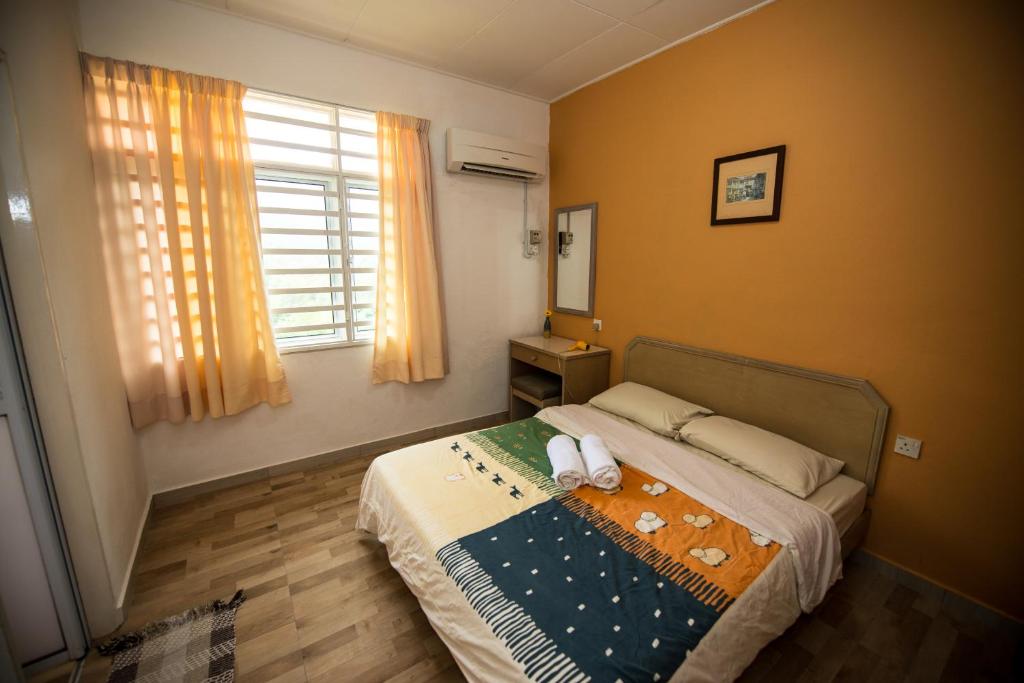 峇都丁宜近海滩珍洁舒适公寓的一间卧室配有一张床,上面有两条毛巾