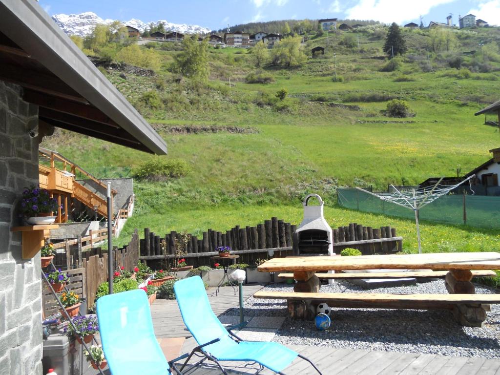 瓦尔富尔瓦帕奥拉旅馆的一个带野餐桌和椅子的庭院和一座小山