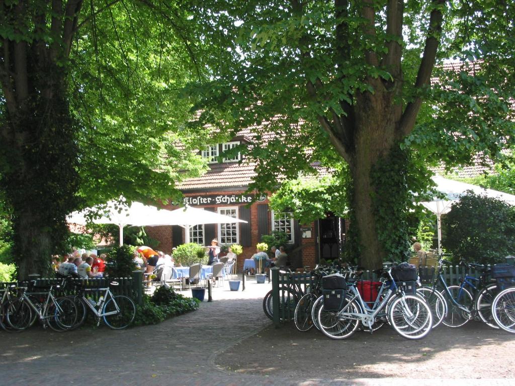 HudeKlosterschänke Hude Hotel Ferienwohnungen Restaurant Café的停在大楼前的一群自行车