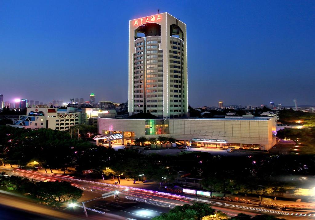 绍兴绍兴咸亨大酒店的一座高大的建筑,晚上有标志