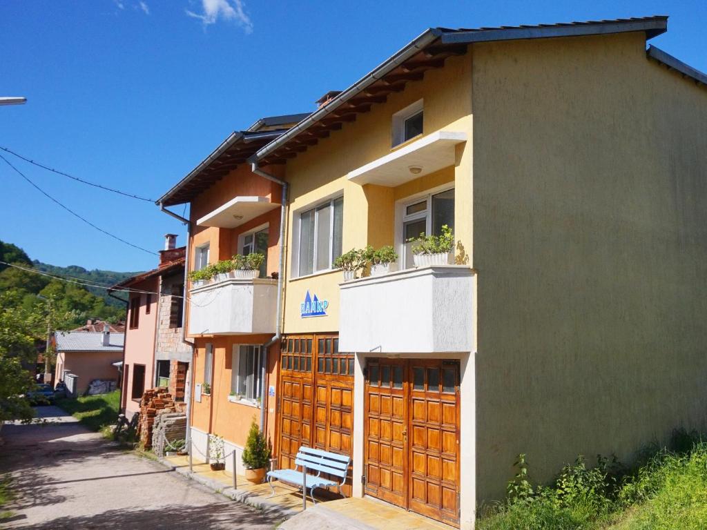 希普科沃Pamir Guest House的街道上设有木门和长凳的建筑