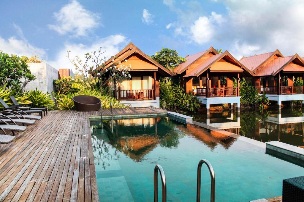 湄南海滩Farmers Villa CoLiving Space的一座带游泳池和木甲板的房子
