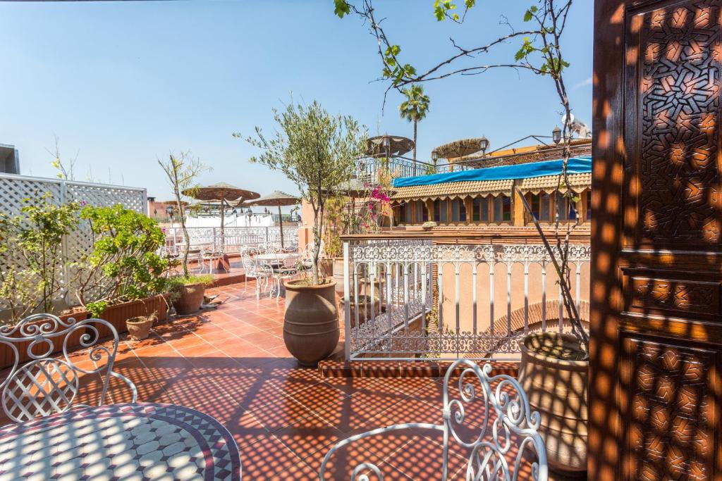 马拉喀什阿特拉斯酒店的一座配有桌椅的庭院和一座建筑