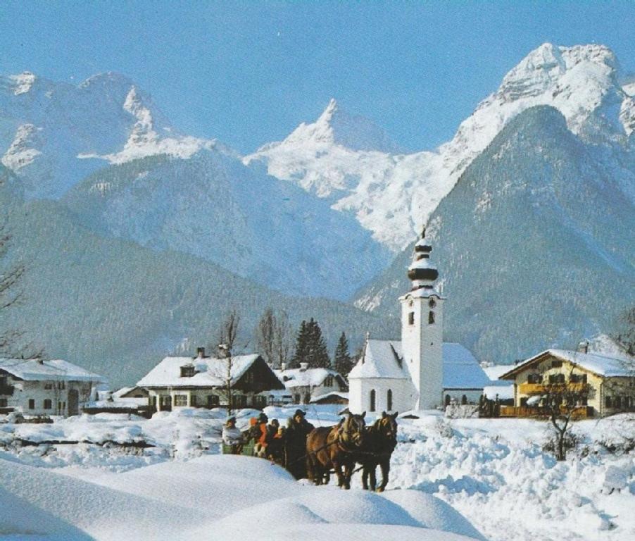 洛弗附近圣马丁Fewo Schlosspark Grubhof的一群骑着马在雪地里的人,有一座灯塔