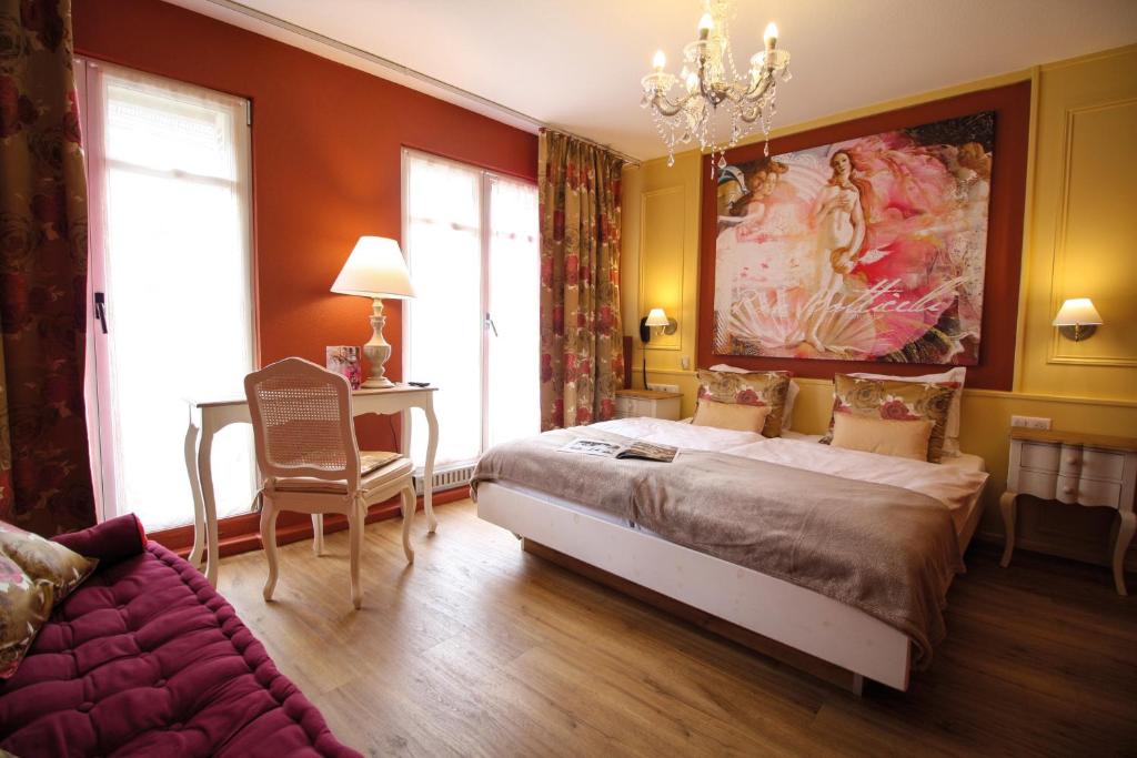 斯特拉斯堡玫瑰酒店的一间卧室配有一张大床和一张沙发
