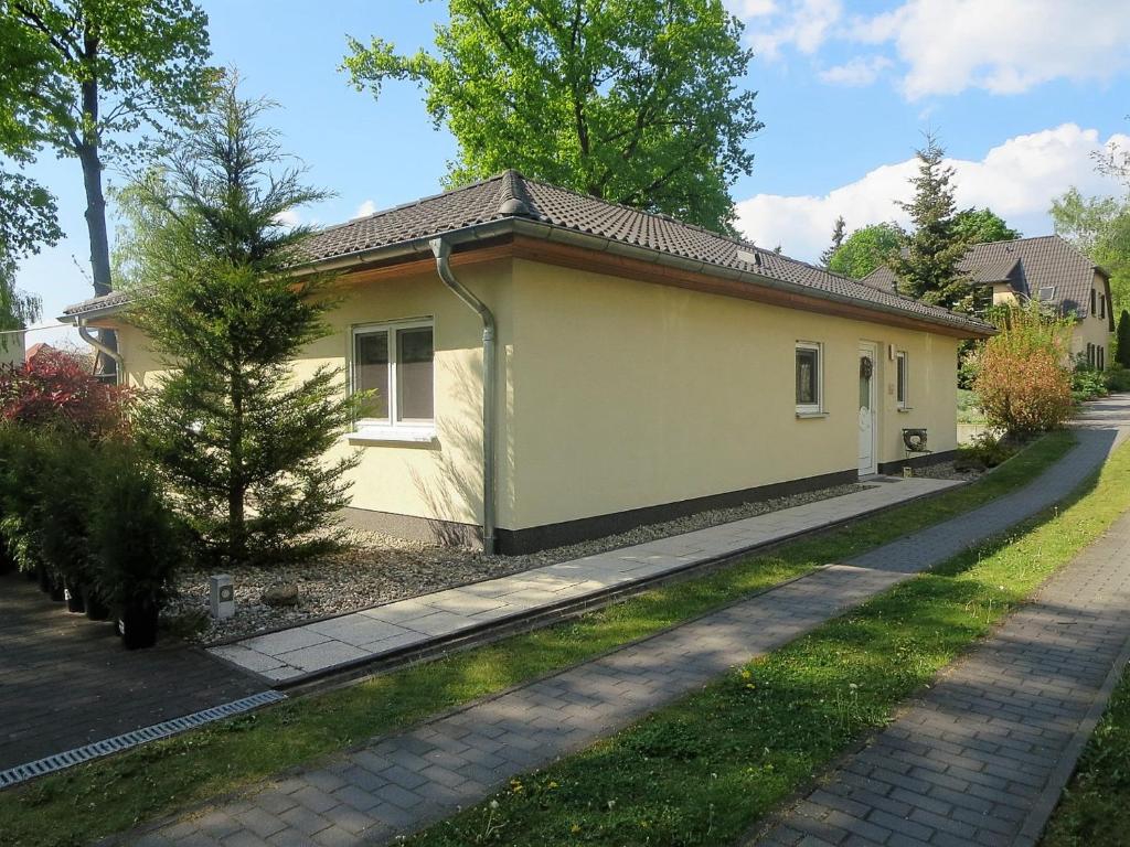 朗斯多夫Ferienhaus Schillo的一条有车道的小黄色房子