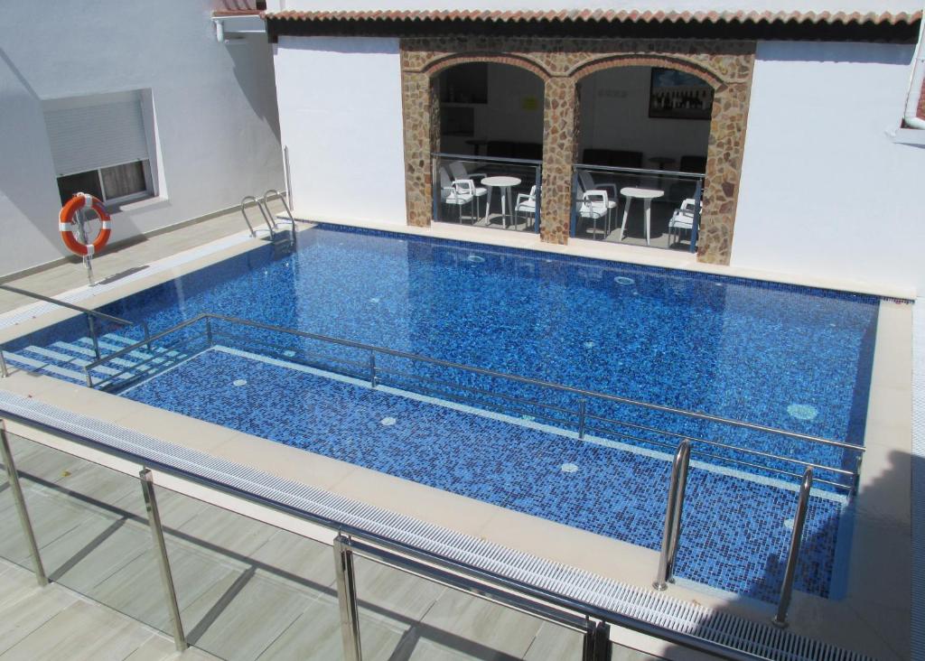 阿兰赫特立尼达德公寓酒店的大楼内一个蓝色的大型游泳池
