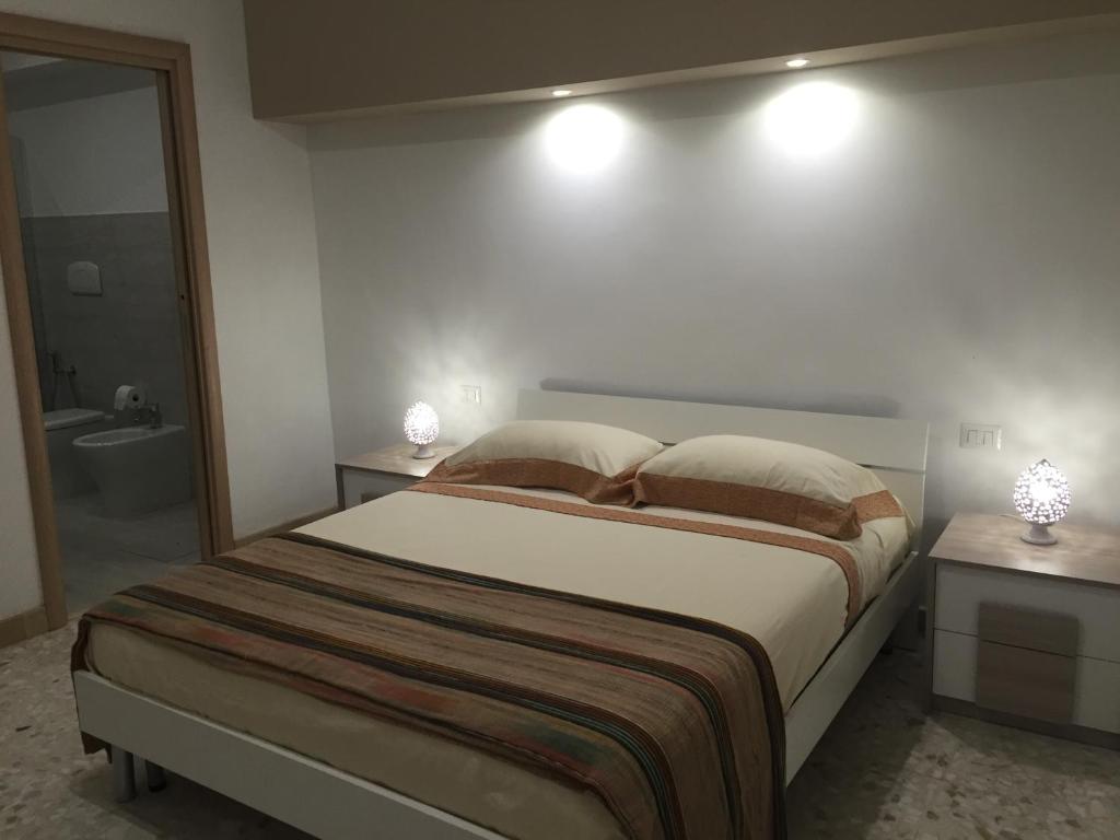 布林迪西Casa Commenda的一间带大床的卧室和一间浴室