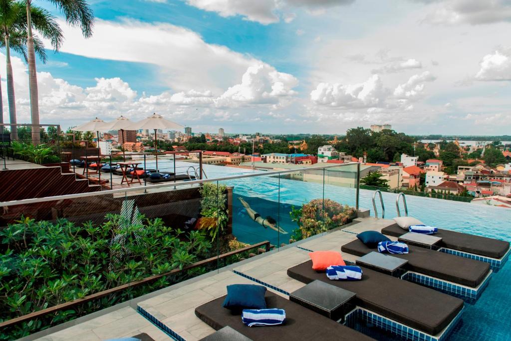 金边宝瓶宫酒店及城市度假村的享有带桌椅的度假村的游泳池景致