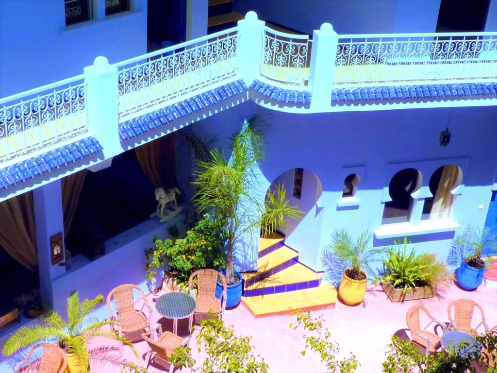 丹吉尔达而奥玛卡延旅馆的一个带桌椅的户外庭院和一个阳台