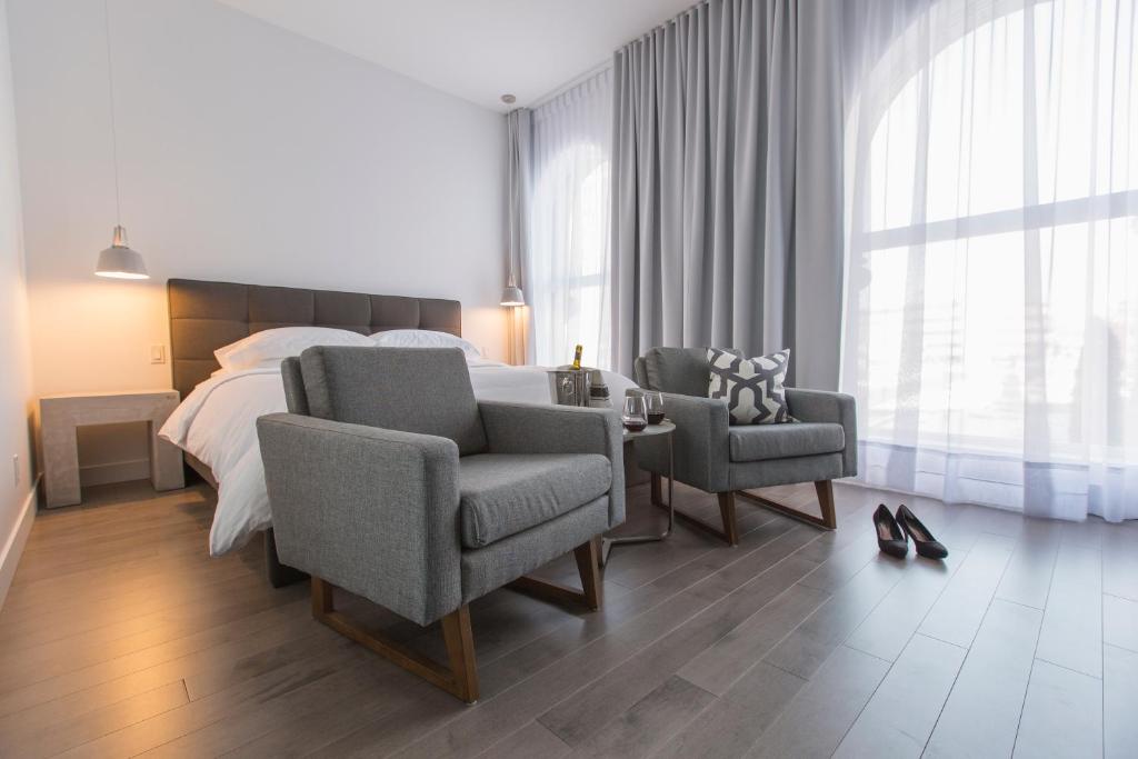 三河城Hotel Oui GO!的一间卧室配有一张床、两把椅子和一张桌子