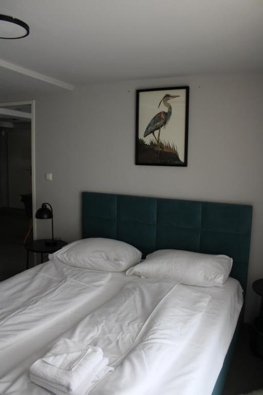 布如克纽多夫Hotel Restaurant Joseph的卧室配有一张床铺,墙上挂着鸟图