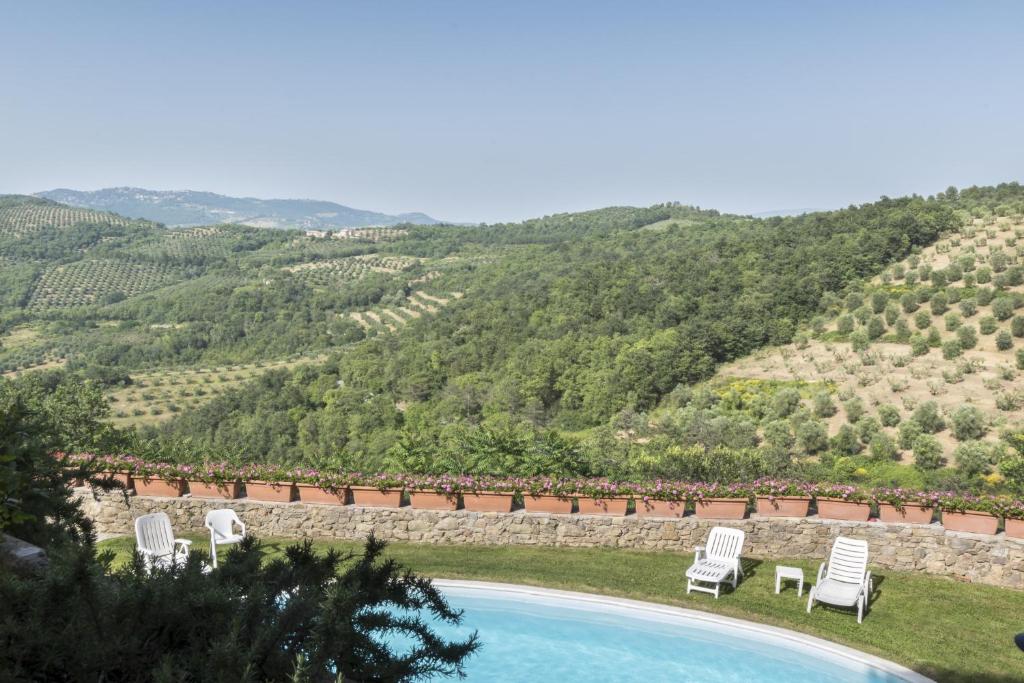 马焦内Agriturismo Borgo Spagnoli的一个带椅子的游泳池,享有山景