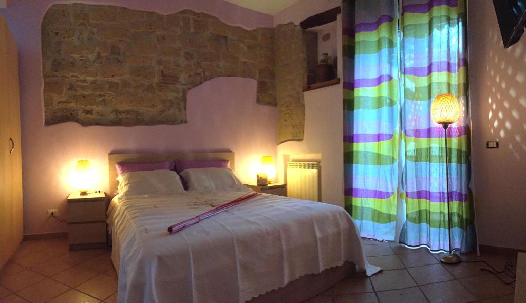 那不勒斯阿莱卡特德瑞住宿加早餐旅馆的一间卧室配有一张大床和两盏灯。