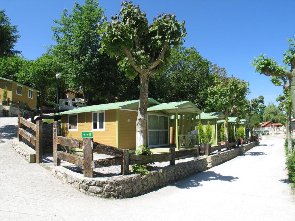 利亚内斯里约普隆营地旅馆的一个带树和围栏的营地