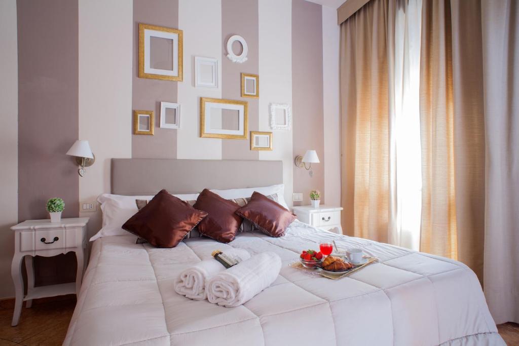 米兰米兰战神酒店的一张带毛巾的白色床和水果盘