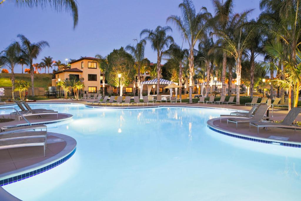 卡尔斯巴德Marbrisa Carlsbad Resort的一座带椅子和棕榈树的大型游泳池