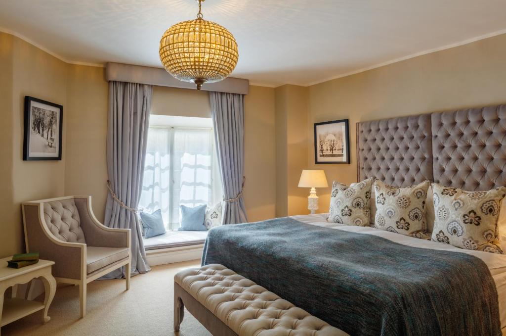 塔林斯古拉萨尔酒店 - 立鼎世酒店集团的卧室配有床、椅子和窗户。