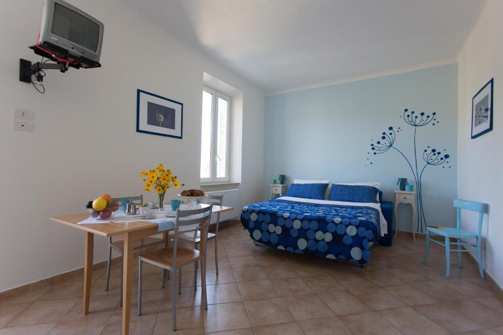 CampofiloneDa Zarè的卧室配有一张床和一张桌子及椅子