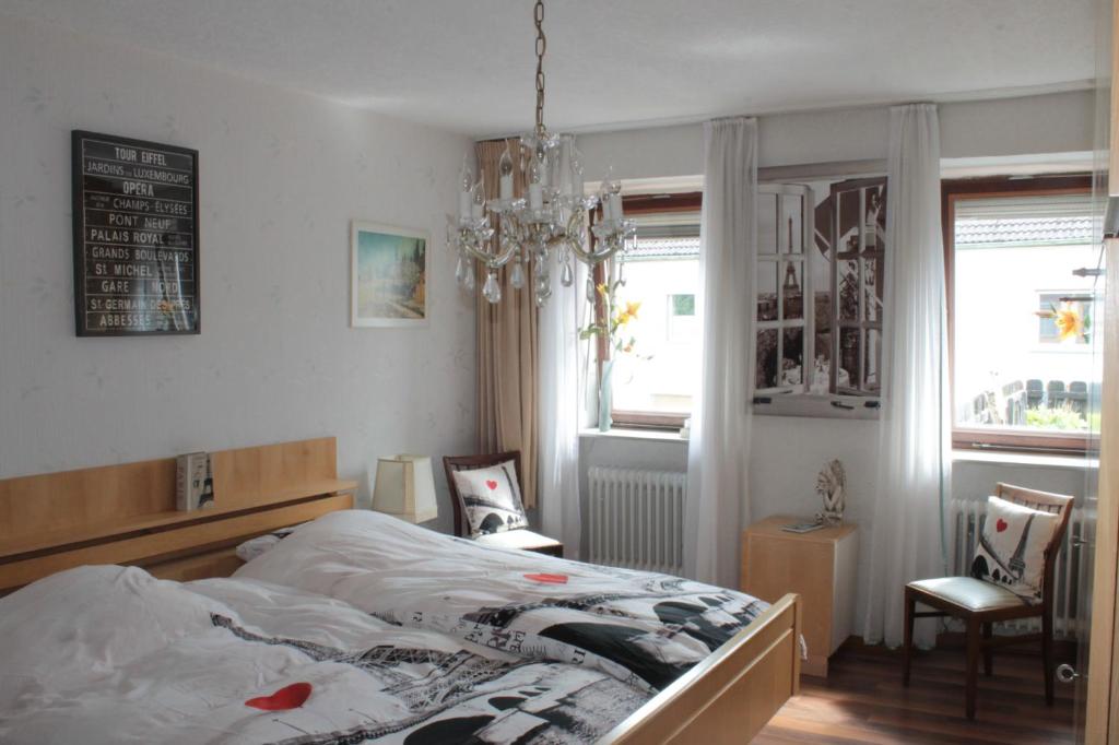 Duppach罗登伯格旅馆的一间卧室配有一张床和一个吊灯