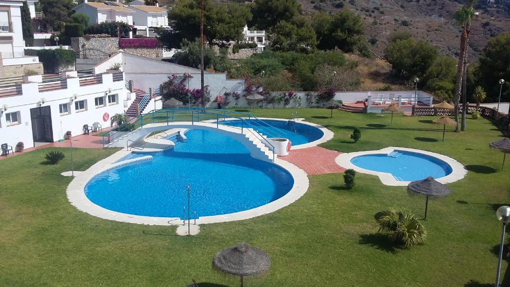 拉海瑞德拉Apartamento Malak的享有庭院内两个游泳池的上方景色