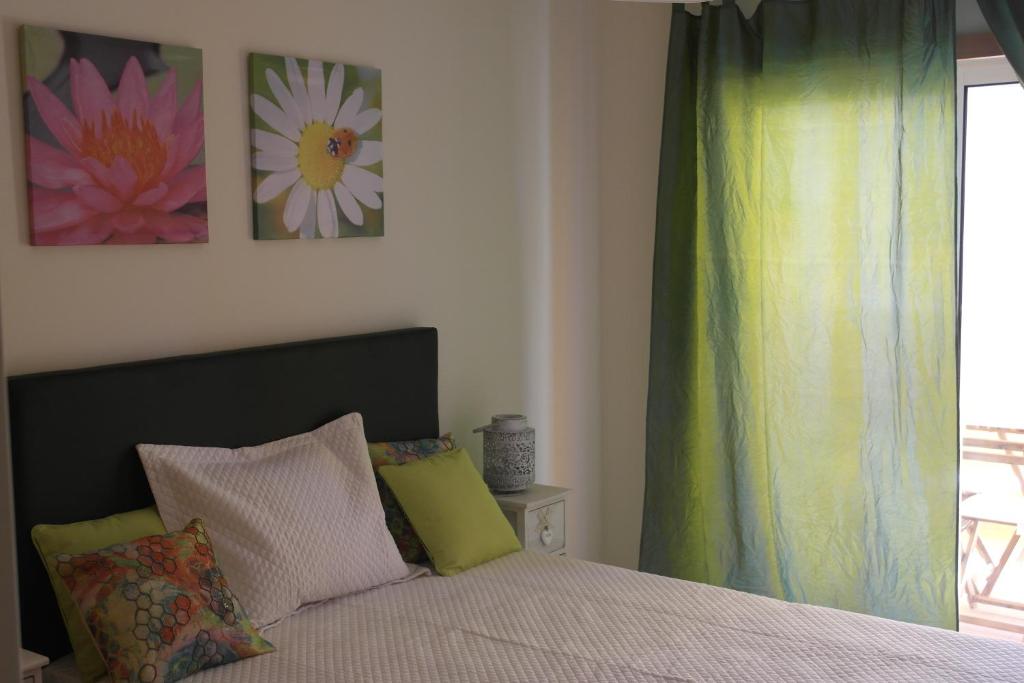 塔维拉Cabanas Apartment的一间卧室设有一张床和一个窗口