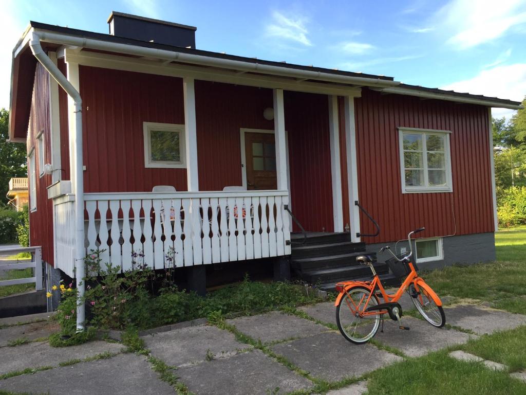 埃克奈斯Lingonberry Cottage的一辆红色的房子,前面停有一辆自行车