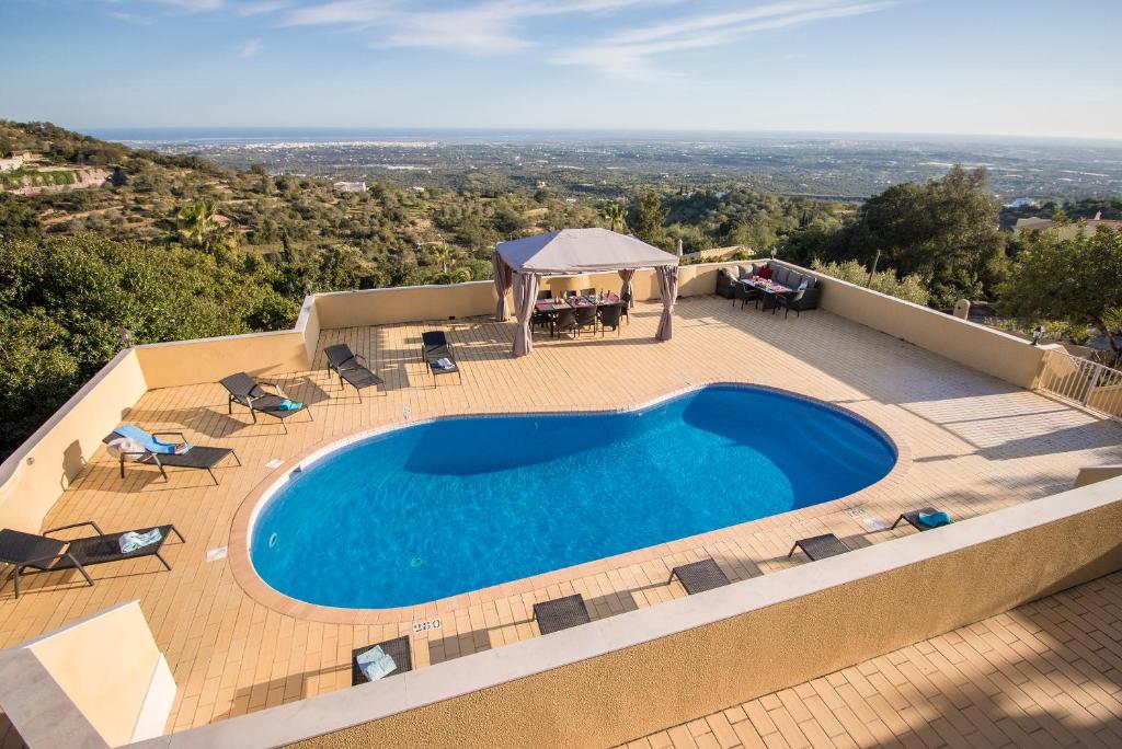 埃斯托伊Villa Panoramica的一个带椅子的游泳池和一个凉亭