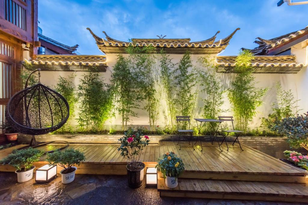 丽江丽江悦途精品度假酒店的建筑中种有盆栽植物的庭院