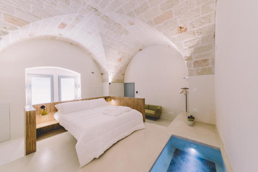滨海波利尼亚诺Cinquevite的一间带大床的卧室和一个游泳池