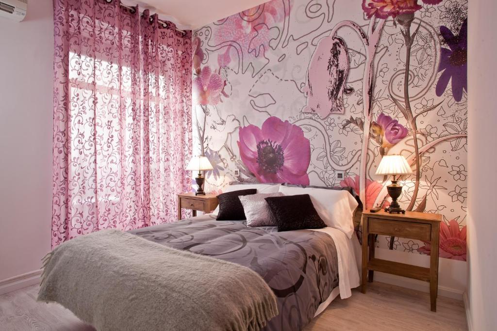 马德里福斯特旅馆的一间卧室配有一张粉红色花卉壁纸的床