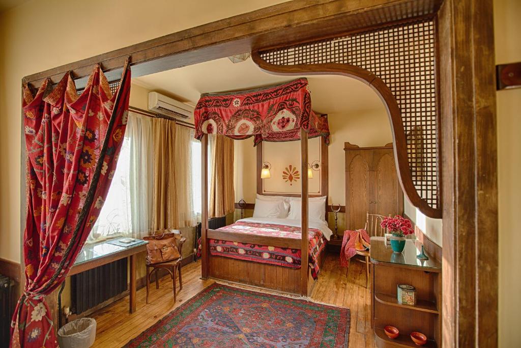 伊斯坦布尔佐伊女皇酒店 的一间卧室,卧室内配有一张天蓬床