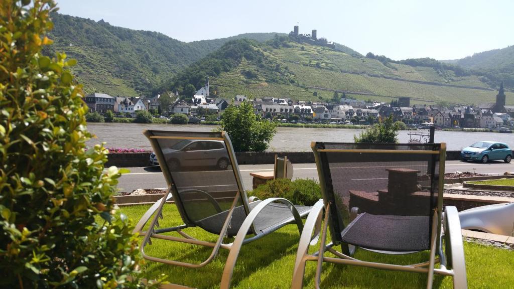 Kattenes城堡山弗里斯酒馆及旅馆的两把椅子坐在草地上,享有城市美景